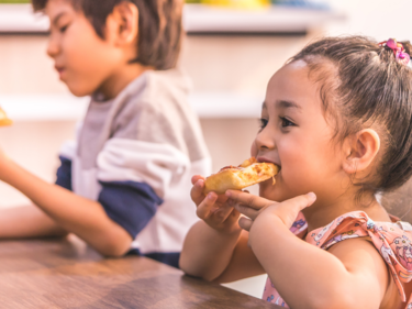 Girl and boy eating pizza