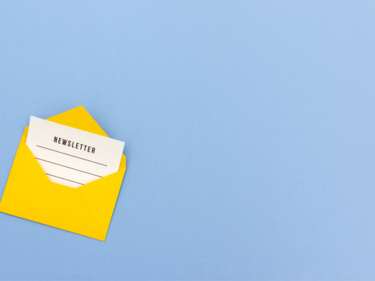 Yellow envelope with paper inside that says "newsletter"