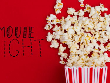 A box of popcorn spilled beside the words "movie night".