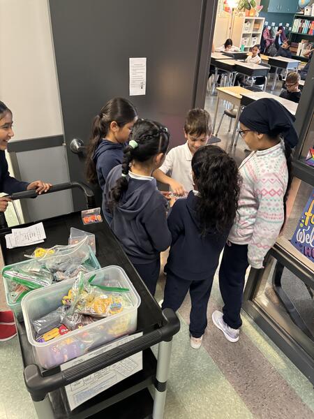 Group of children handing out prizes.