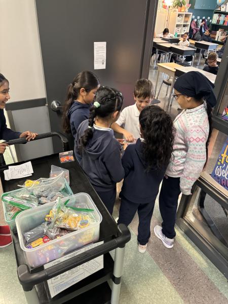 Group of children handing out prizes.